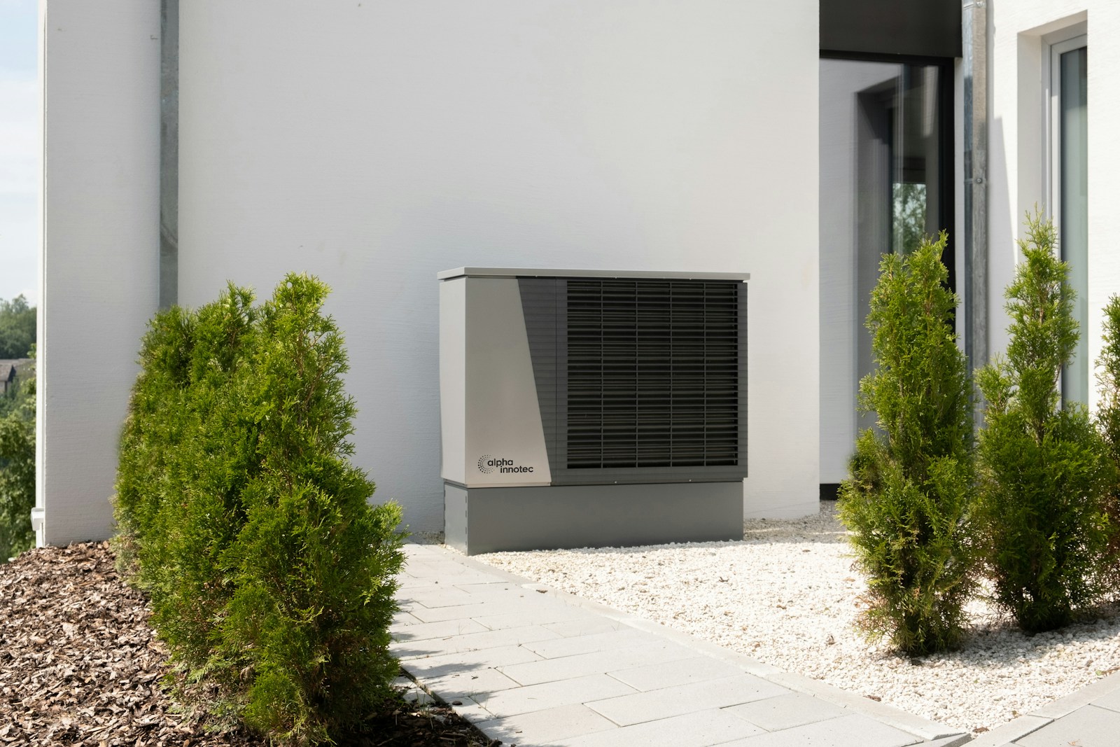 Air source heat pump installed beside a modern home
