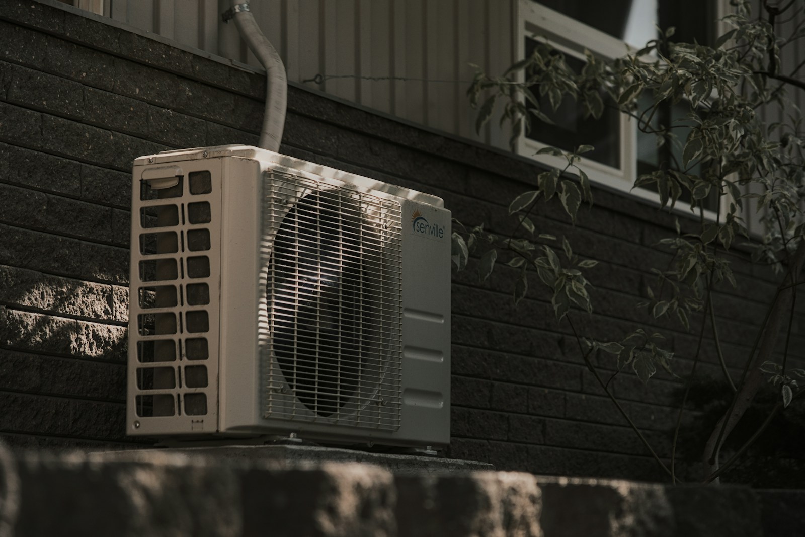 Air conditioning condenser unit installed at a home